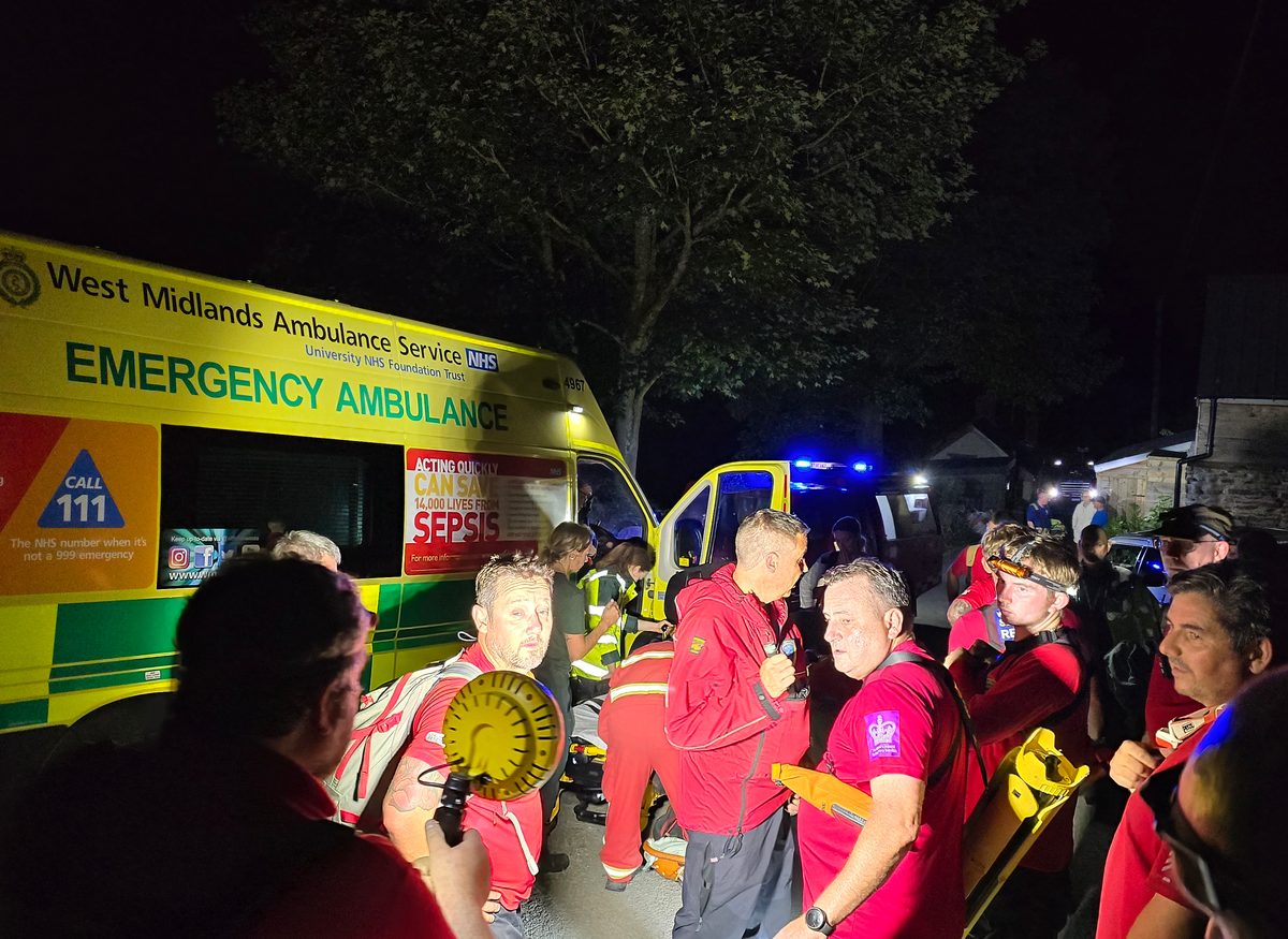 WMSAR volunteers alongside a West Midlands Ambulance Service crew at night