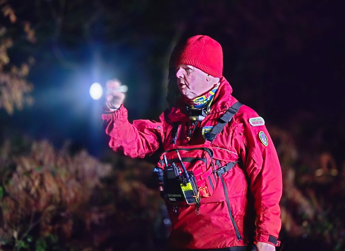 A WMSAR search technician directing teams on a night search